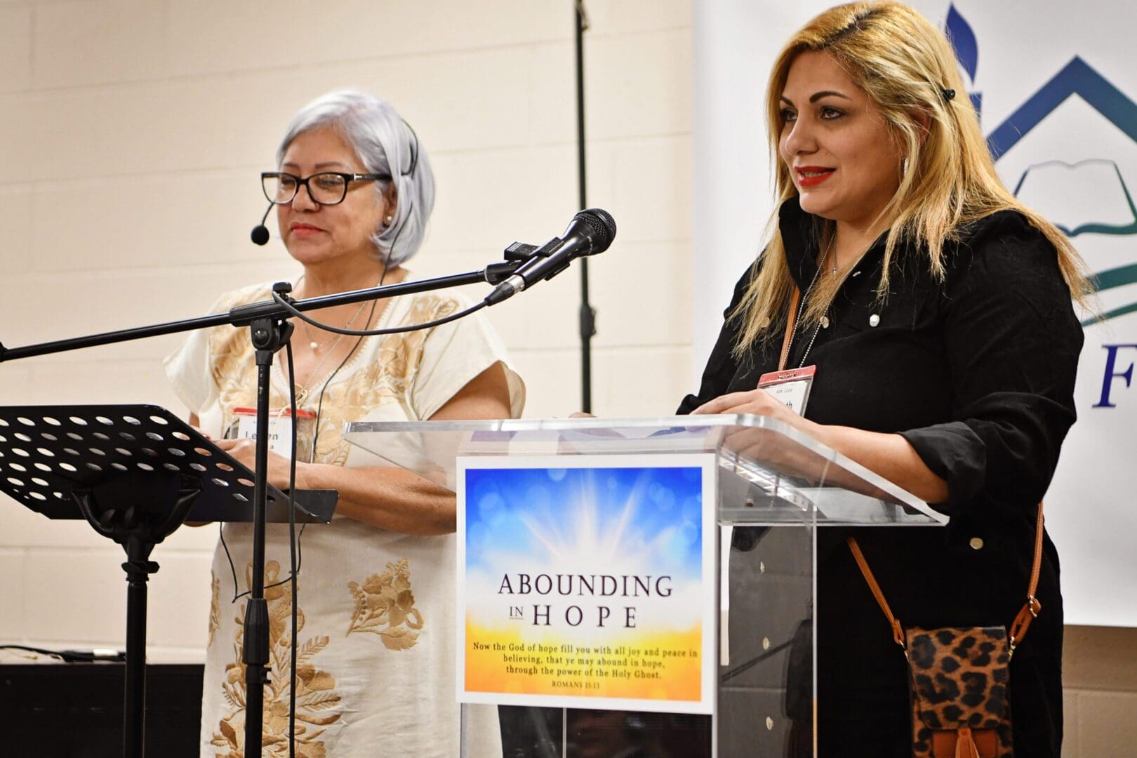 Two women speaking at a podium during an event